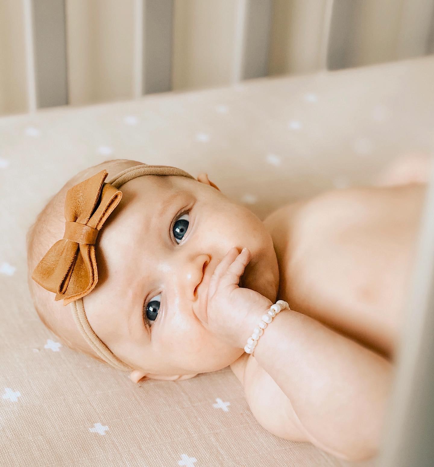 1 copy of cottonmuslincribsheet.lifestyle.taupecross.littleunicorn.jpg