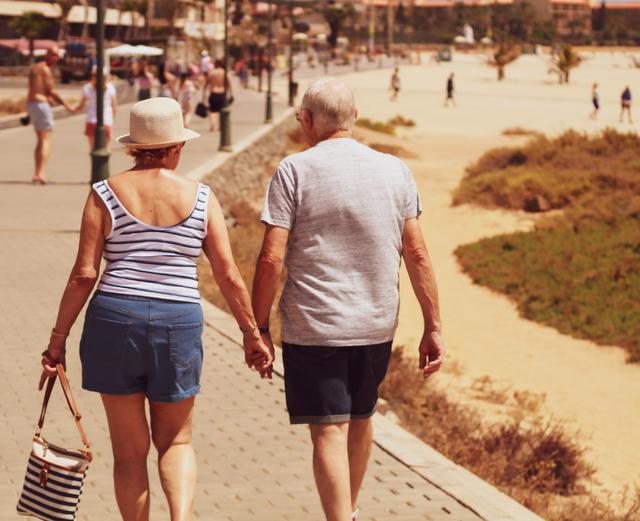 Image of two seniors taking a walk wearing wearable technology fro Doha.