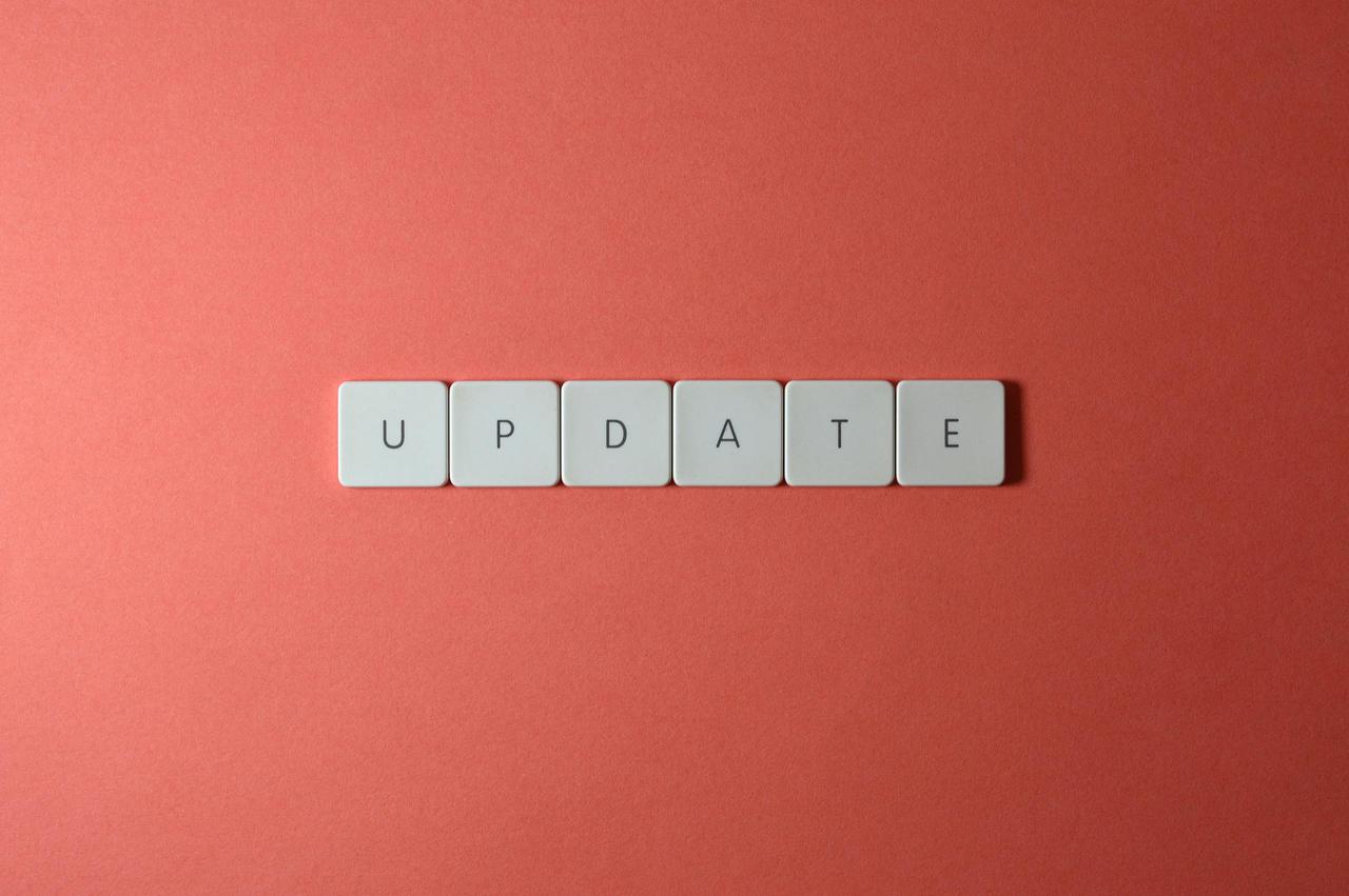 Keyboard keys arranged to spell 'update' on a vibrant red background, ideal for conveying tech concepts.