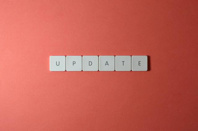 Keyboard keys arranged to spell 'update' on a vibrant red background, ideal for conveying tech concepts.