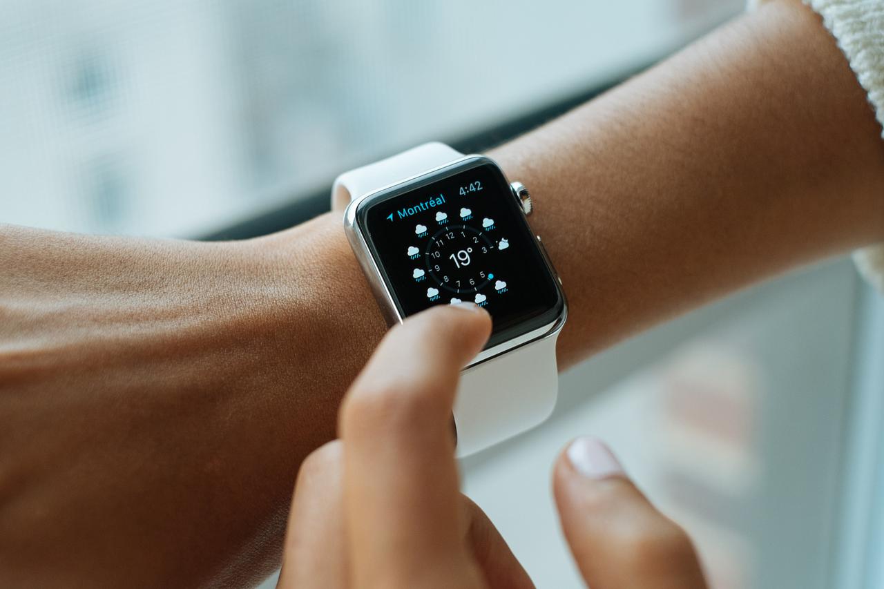 Someone looking at their apple watch wondering how can wearable technology affect your privacy.