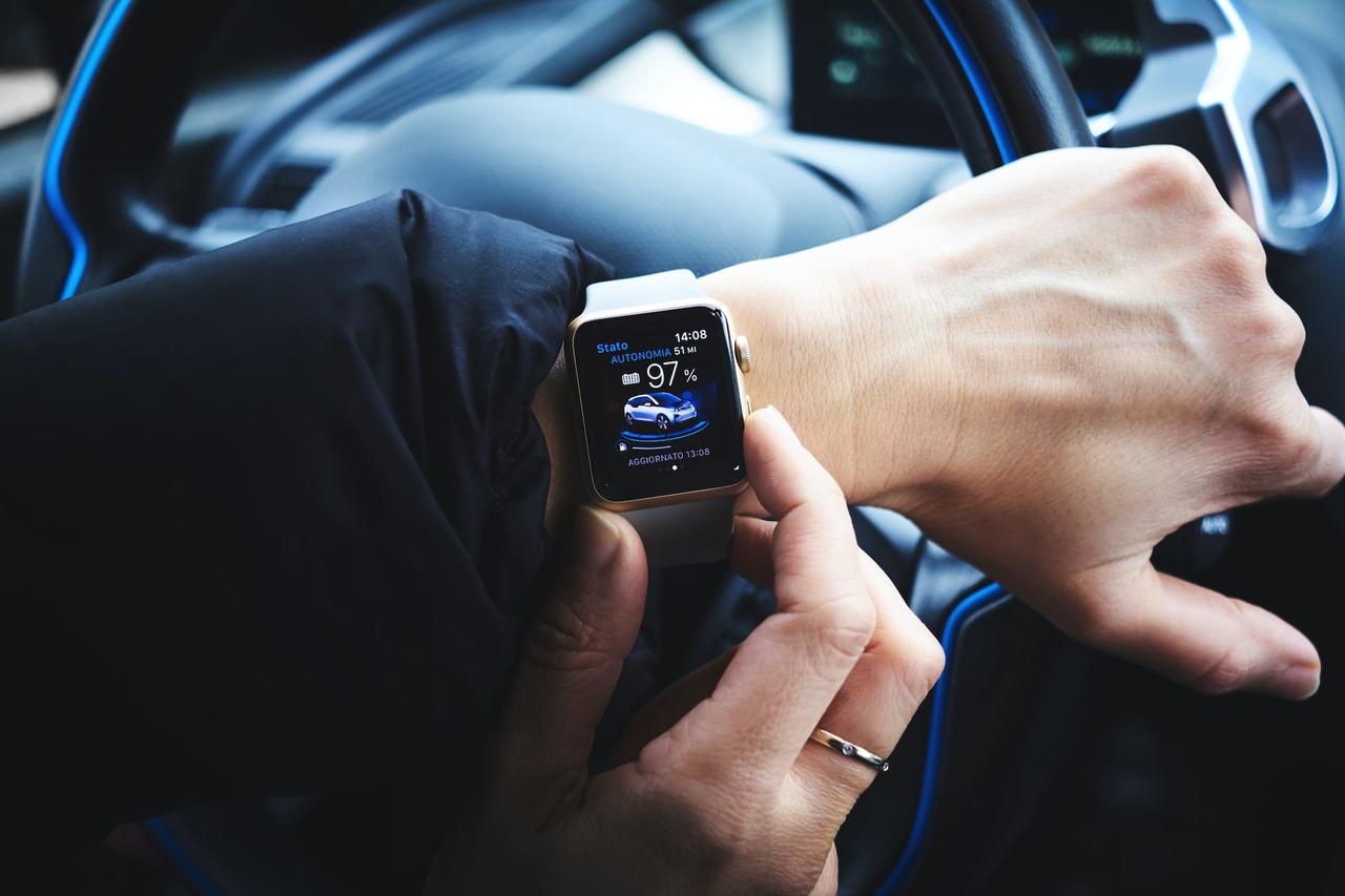 Man controlling car using his smartwatch