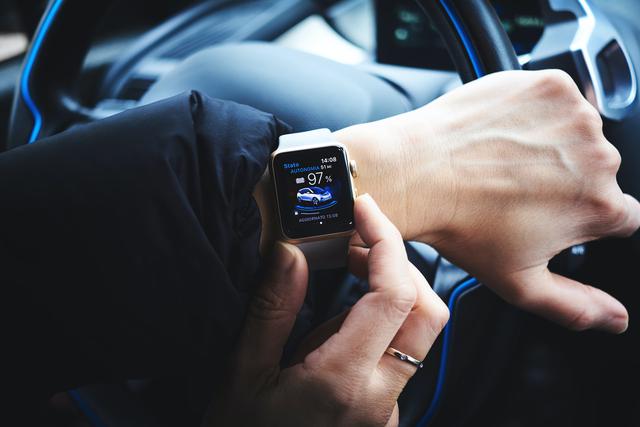 Man controlling car using his smartwatch