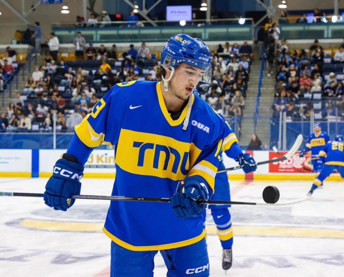 Professional hockey coach instructing young athletes during training