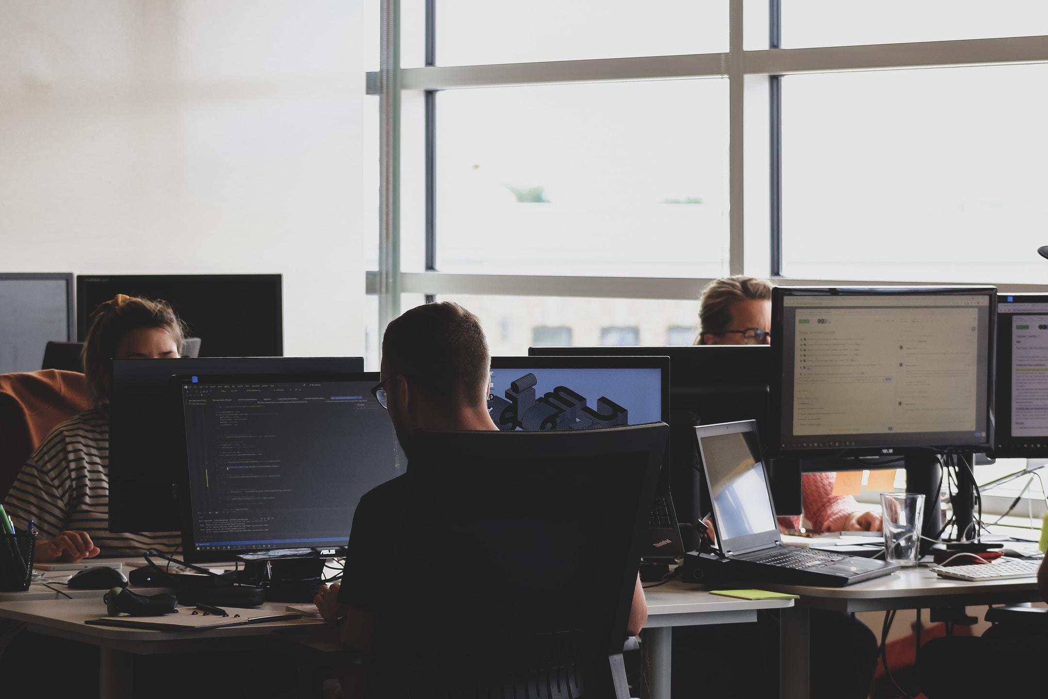 Image of a group of people working from a data breach playbook after getting hacked.