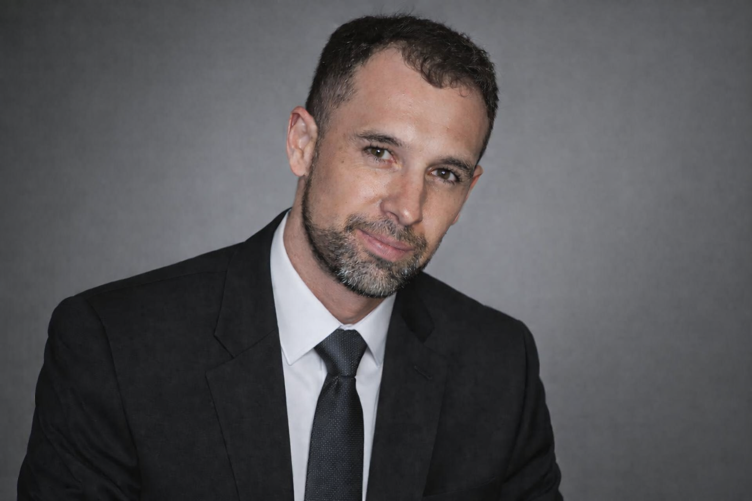 Abel Jimenez, Founder and Principal of SGA Praxis, standing confidently in a conference room