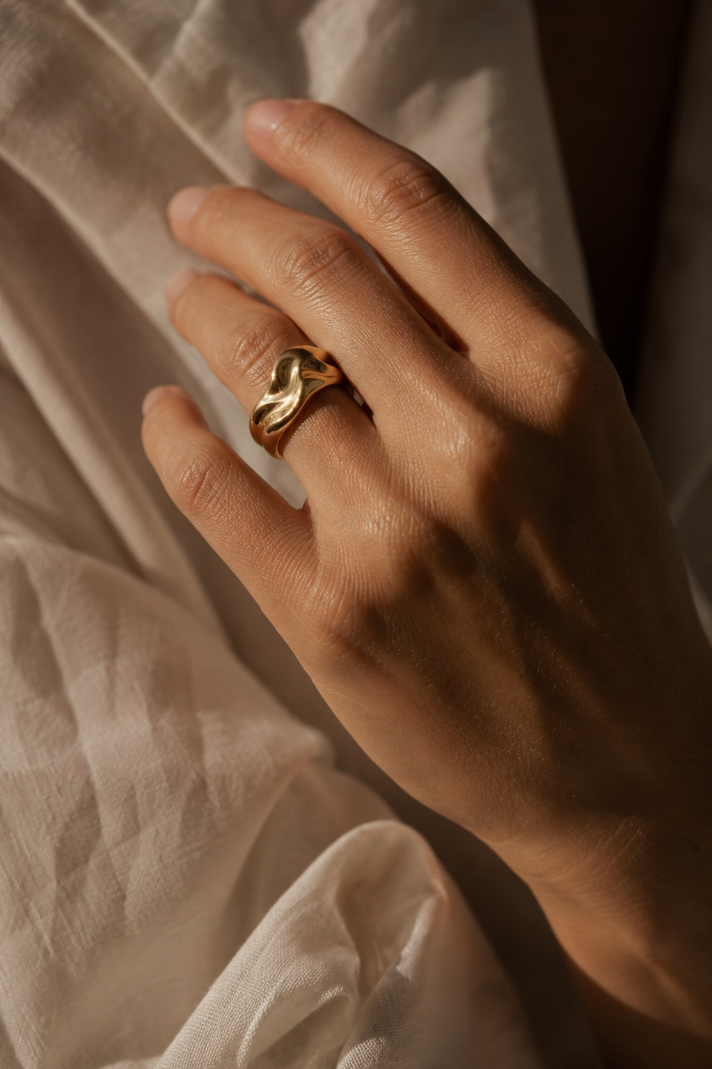 Sculptural 18k gold ring on a woman's hand