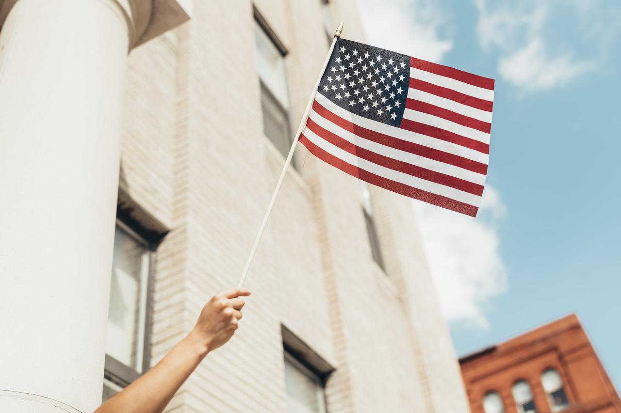 Waving American Flag Across City