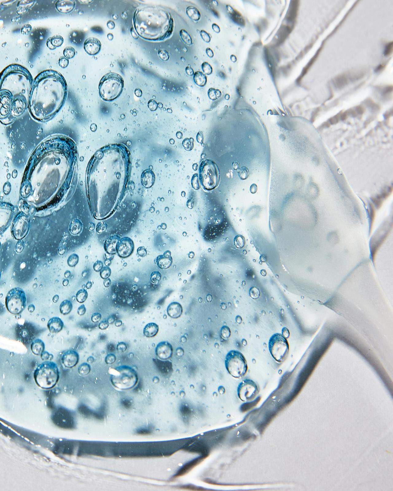 Macro shot of clear cosmetic gel with air bubbles showing texture and clarity.