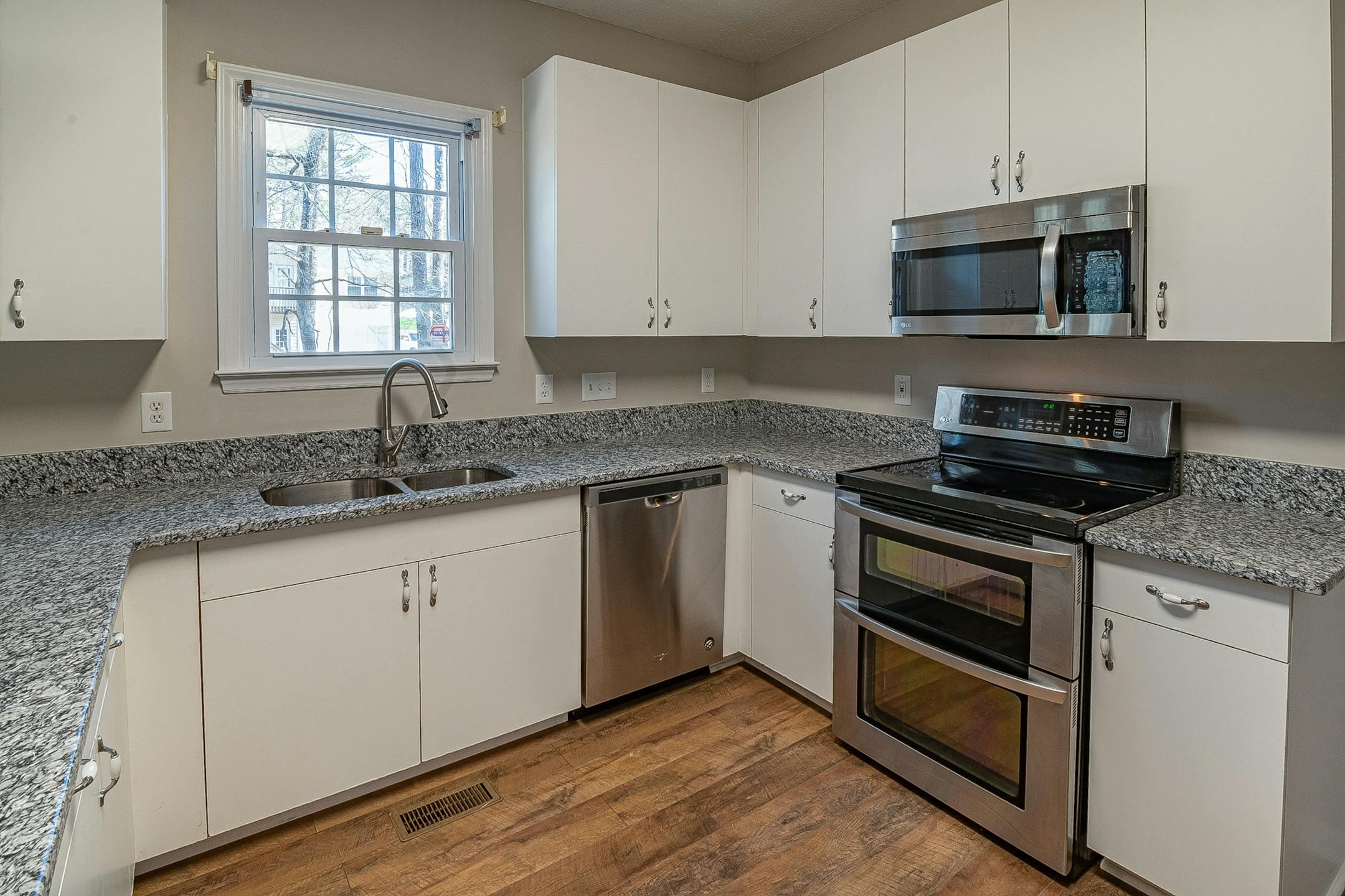 A sleek modern kitchen featuring stainless steel appliances and granite countertops.