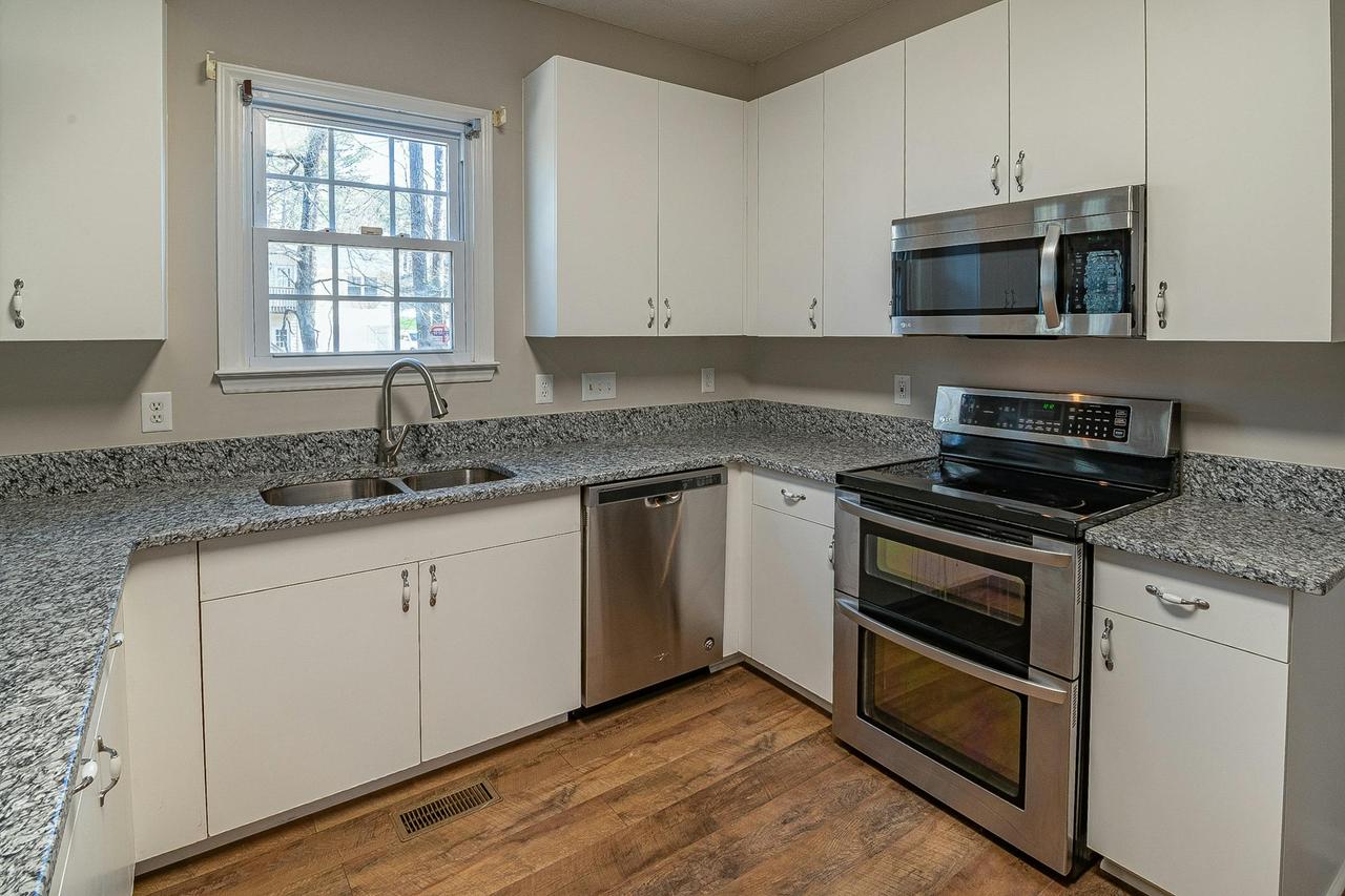 A sleek modern kitchen featuring stainless steel appliances and granite countertops.