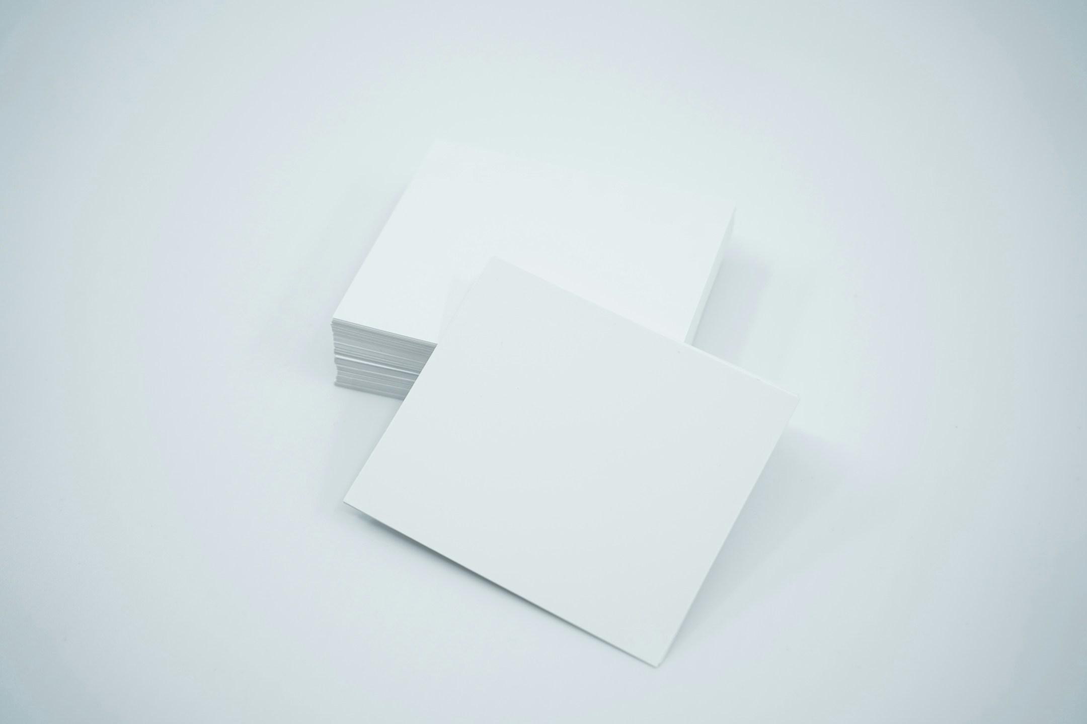 Mockup scene featuring a stack of blank white business cards on a studio gray background