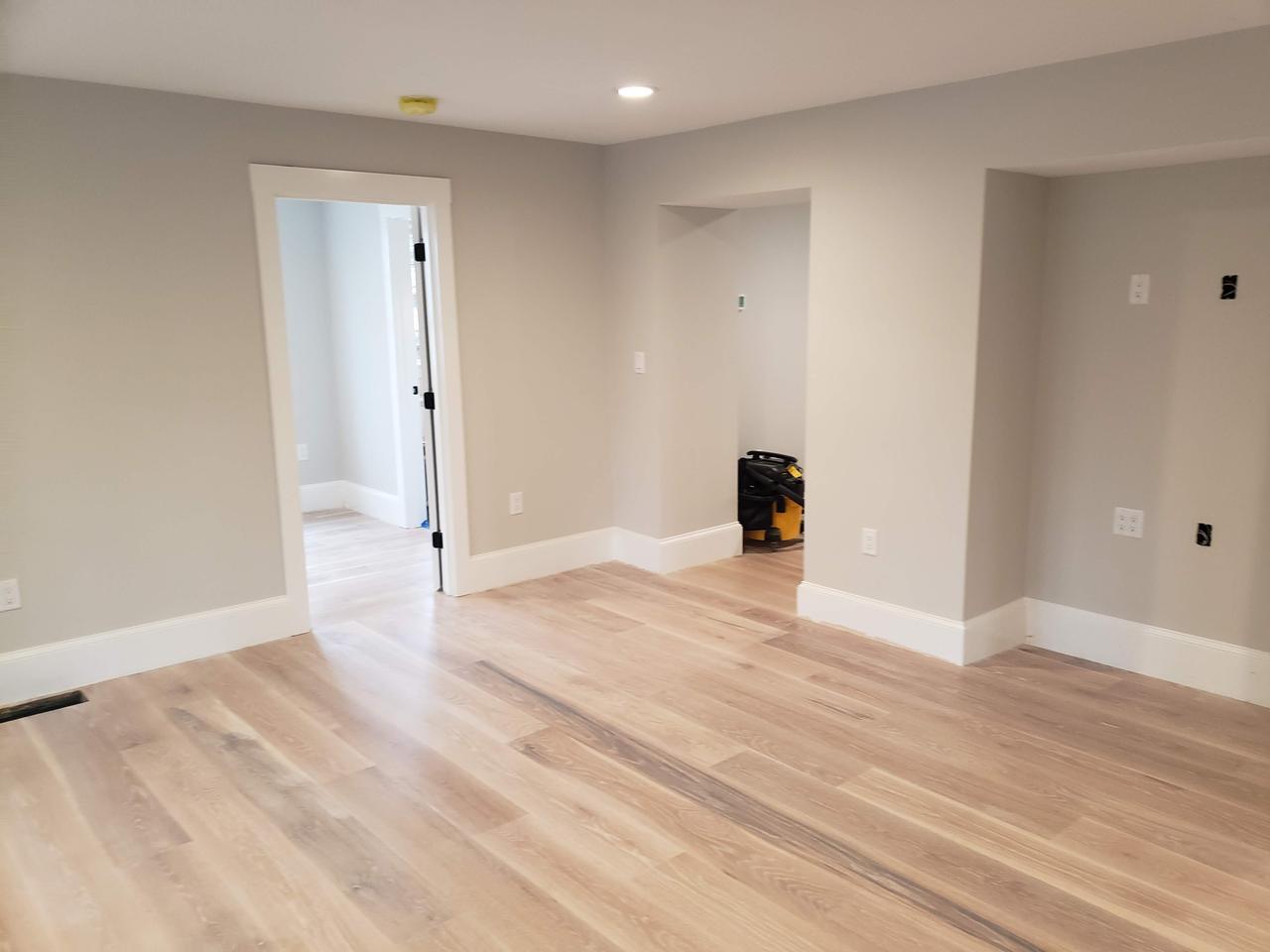 family-room-freshly-painted-in-grey-with-light-wood-flooring