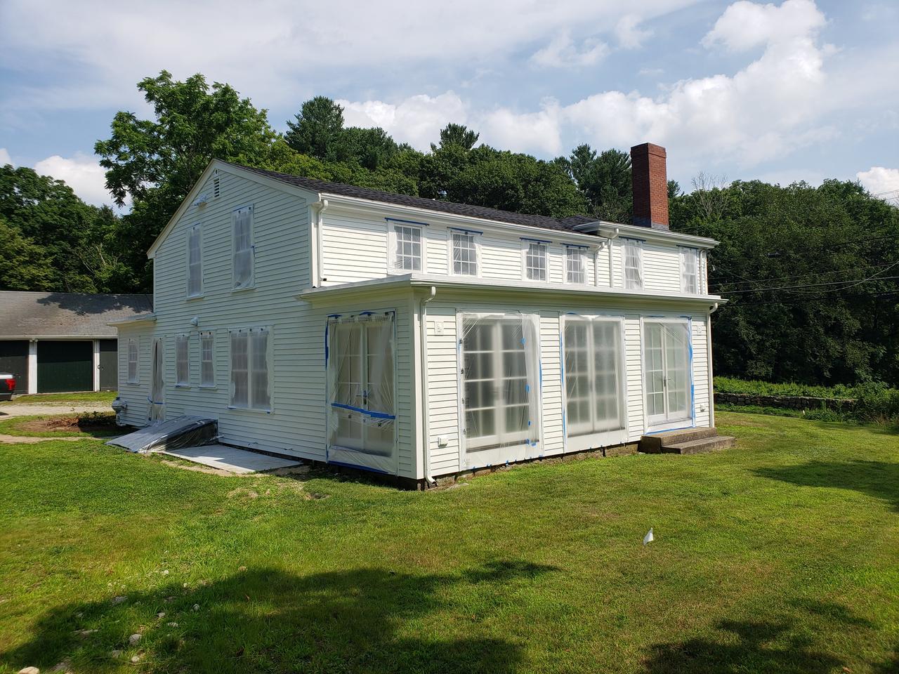 white-house-with-sunporch-primed-and-ready for-final-coat-of-paint