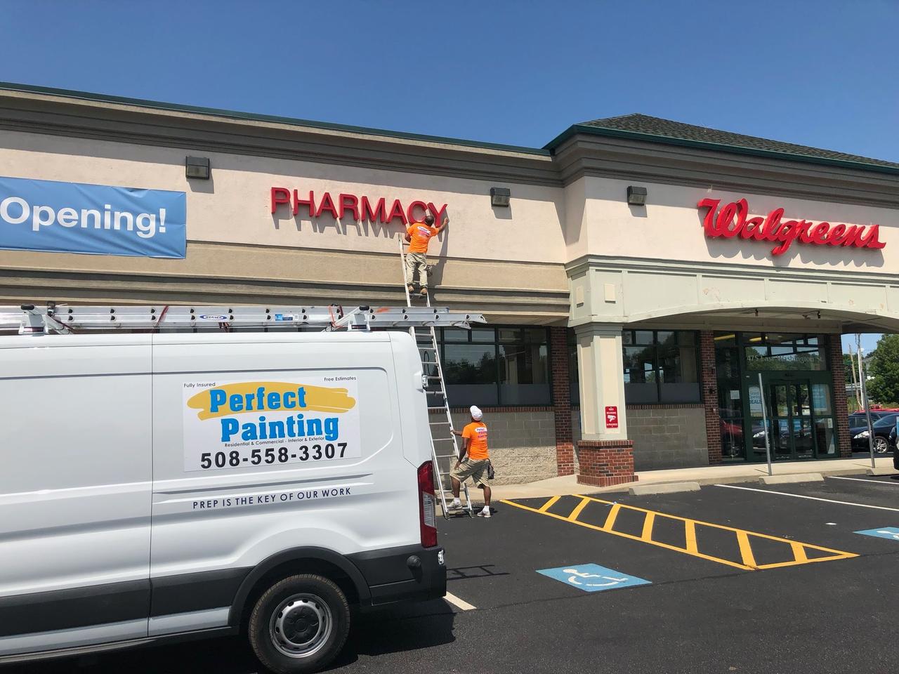 two-males-with ladder-painting-building-exterior-of-walgreens
