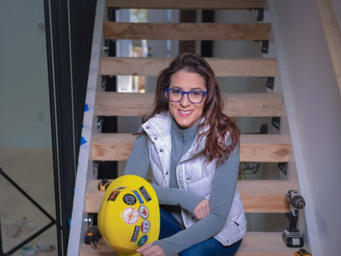 andrea-with-hard-hat-and-stairs-682x1024-1753376207605.jpg