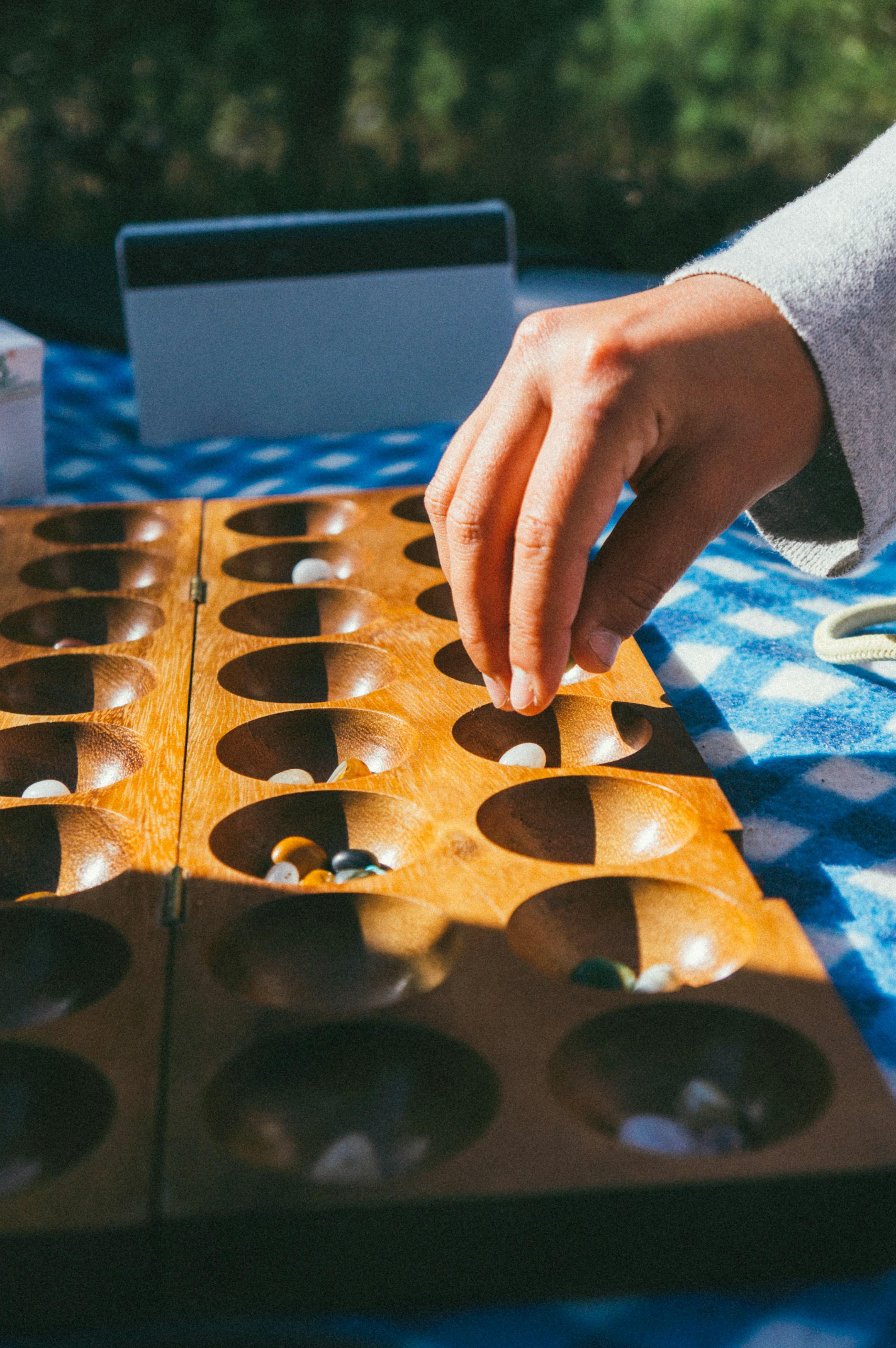 Person playing mancala the game