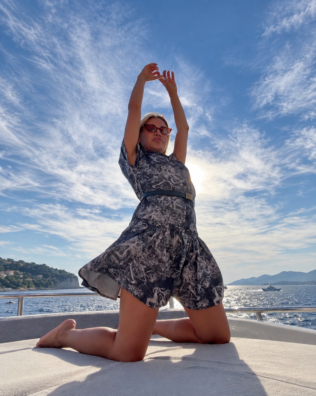 French Riviera luxury advisor Sylwia Kaminska aboard a chartered yacht with Mediterranean views, representing integrated lifestyle solutions