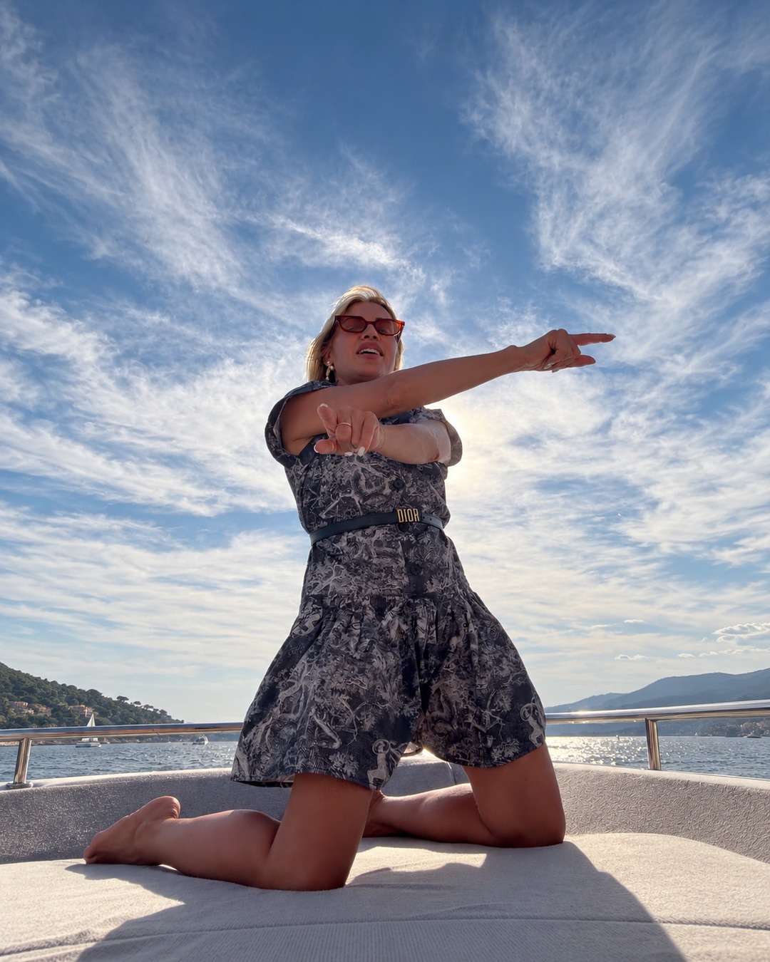 Sylwia Kaminska overlooking the Mediterranean from a luxury yacht charter, representing the pinnacle of Saint-Tropez sophisticated lifestyle management