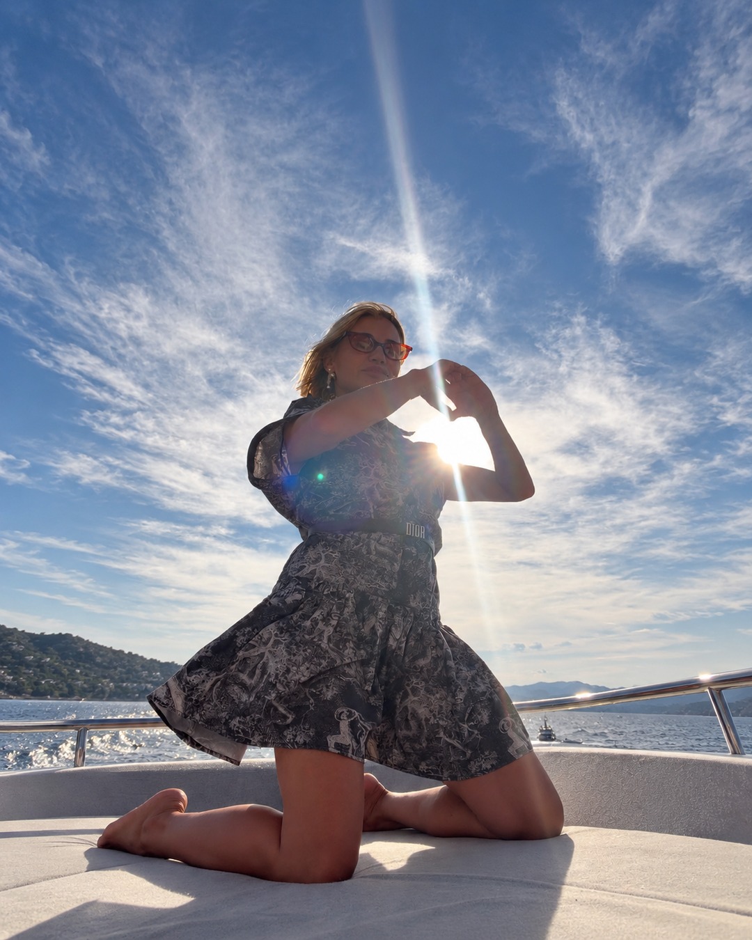 Sylwia Kaminska, expert in French Riviera integrated luxury, positioned aboard a superyacht near Saint-Tropez's exclusive waters