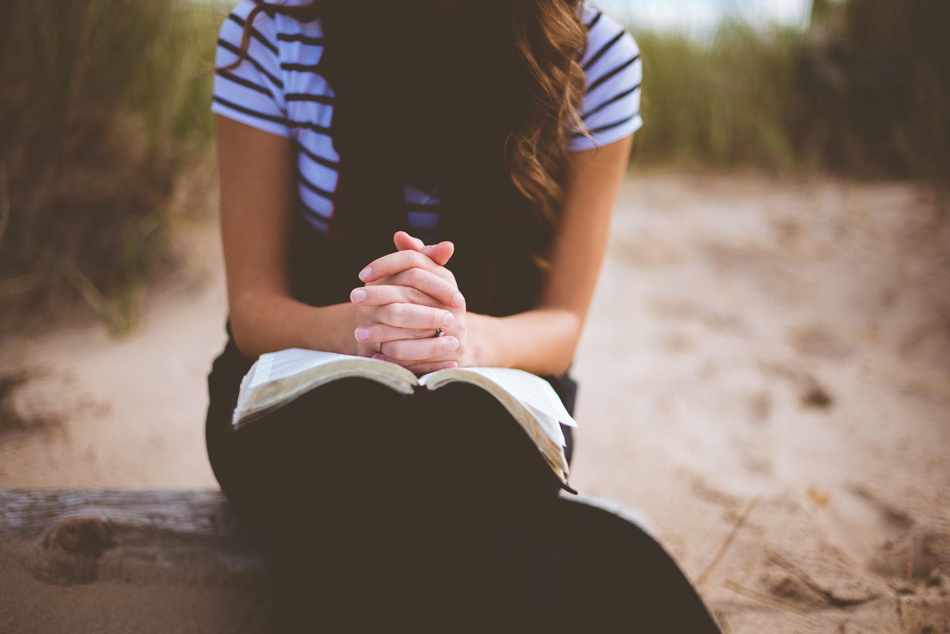 woman with open bible on her lap