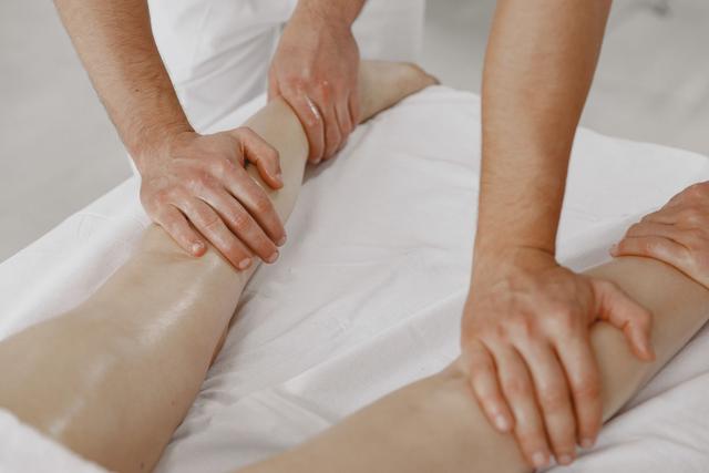 A close-up view of a leg massage in a relaxing spa environment.