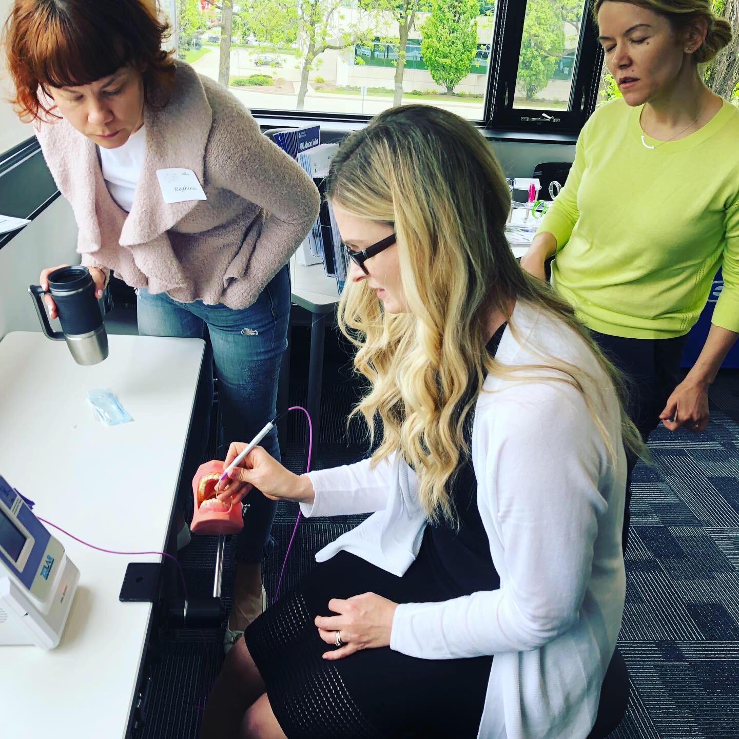 This is a picture of a student during dental hygiene laser training.