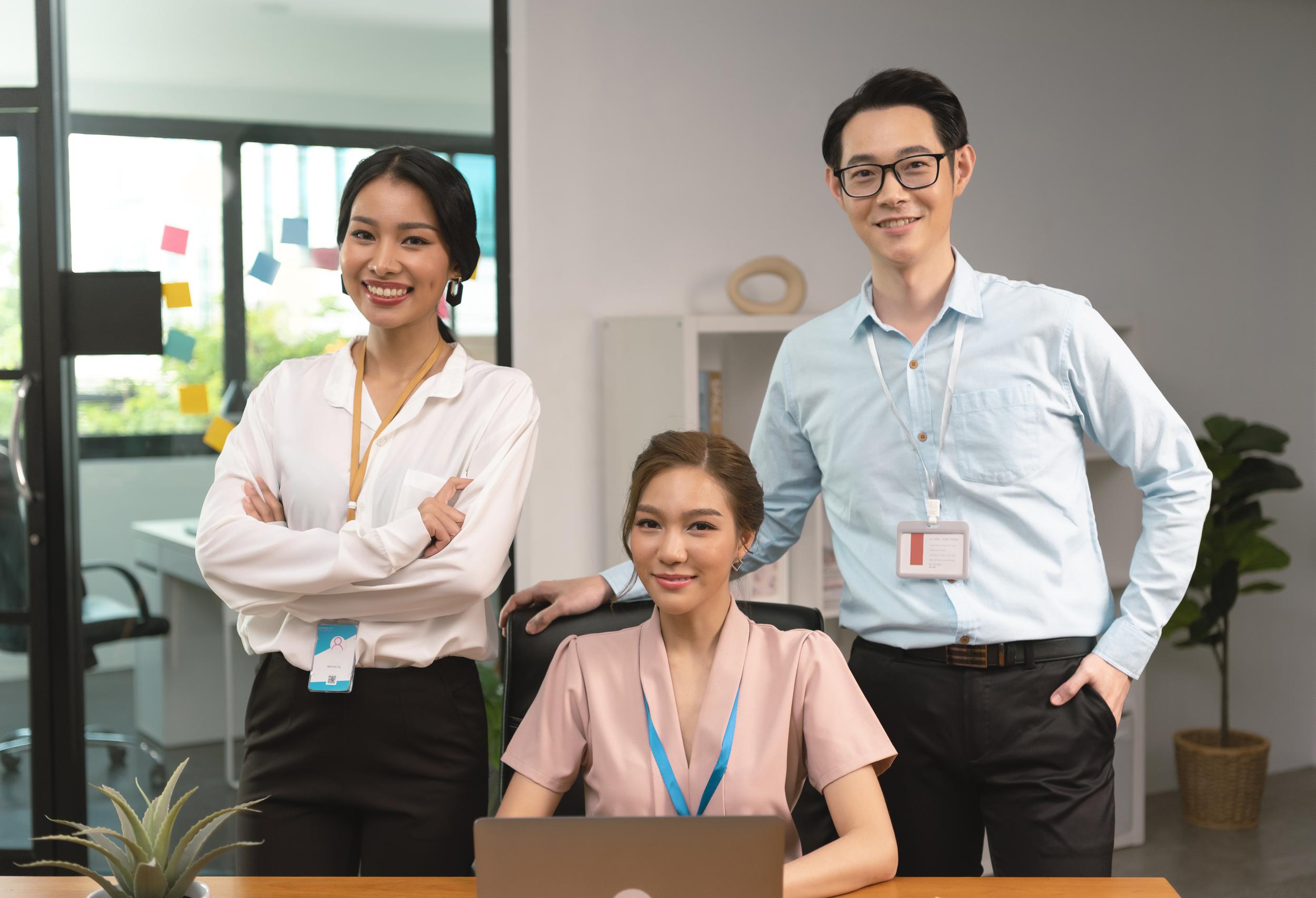 asian-business-team-of-office-colleagues-standing-2024-12-07-00-39-28-utc.jpg