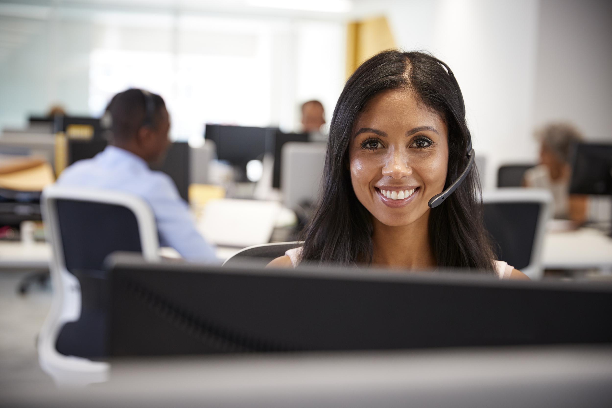 young-woman-working-at-computer-with-headset-in-bu-2024-10-20-10-08-07-utc.jpg