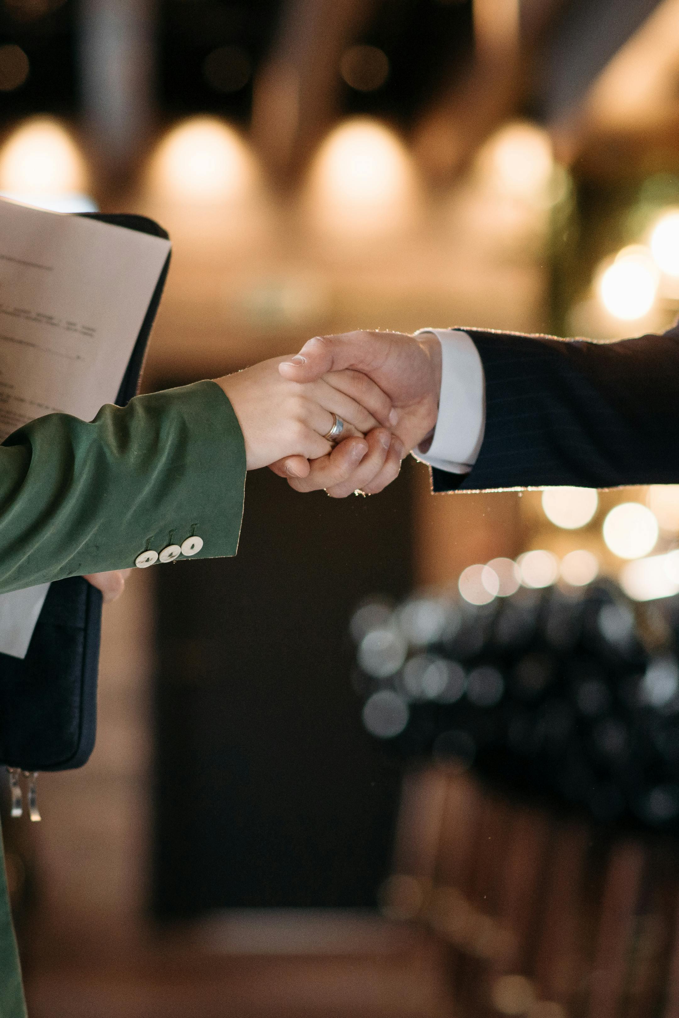 Close-up of two professionals shaking hands, symbolizing a successful partnership agreement.