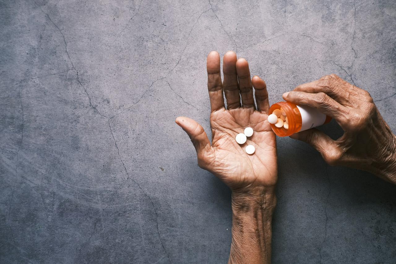 senior hand holding pills with copy space ,
