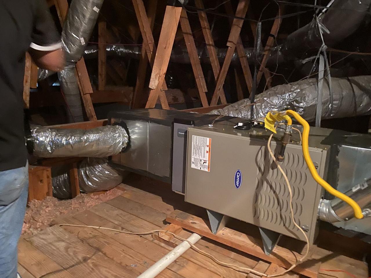 Carrier gas furnace installed in an attic with new ductwork connections in Spring, TX