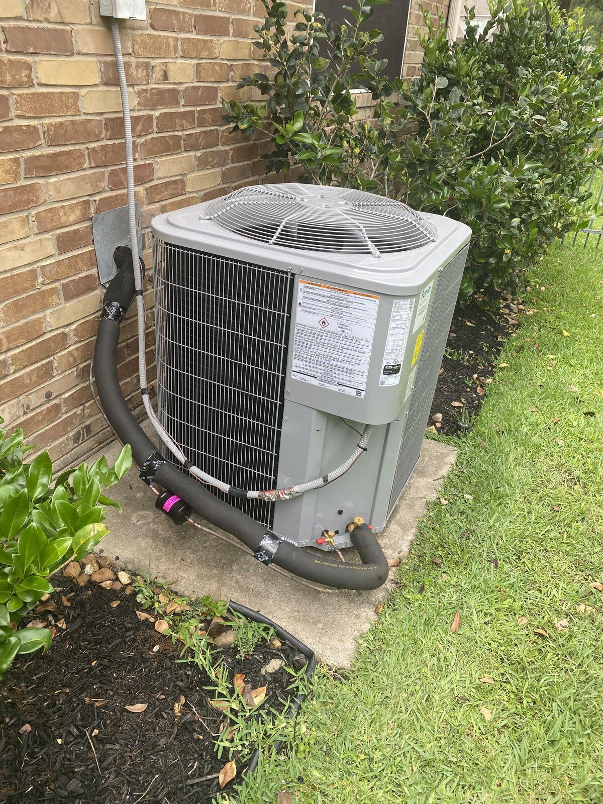 Carrier condenser with newly insulated refrigerant lineset installed at a Spring, TX home