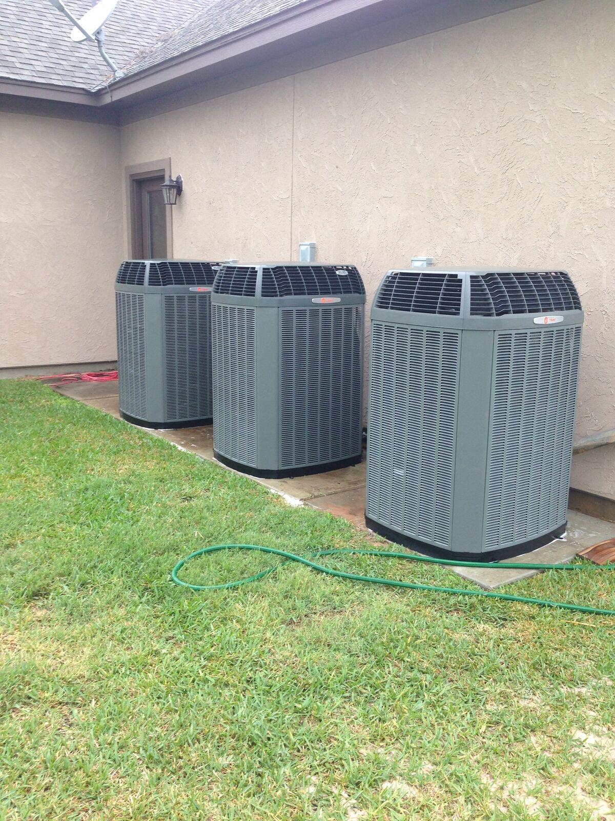 Three Trane XL20 high-efficiency condensers installed at a stucco home in Spring, TX