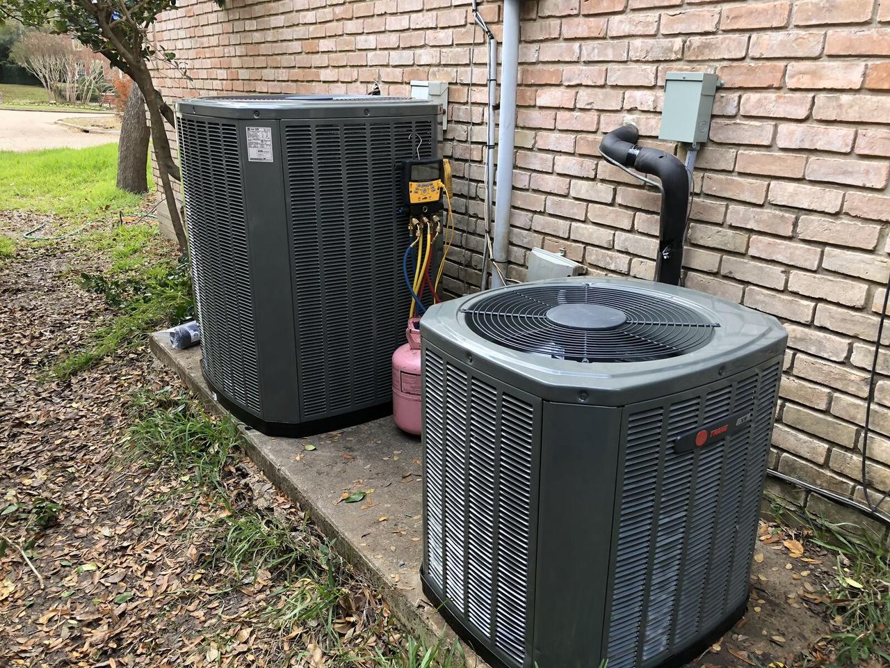 Two Trane XR condensers being commissioned with refrigerant gauges in Spring, TX