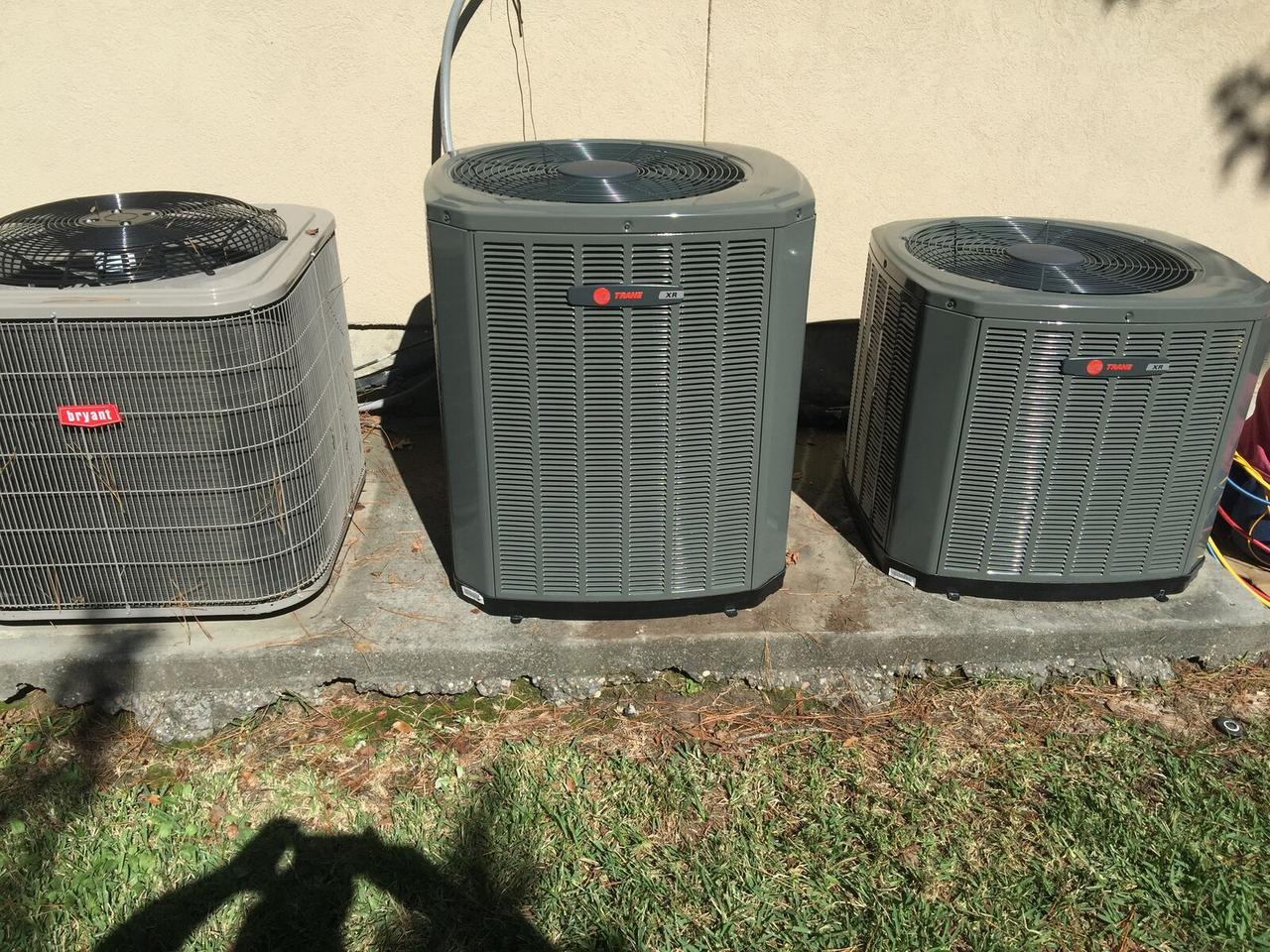 Two new Trane XR air conditioner condensers replacing an older unit in Spring, TX