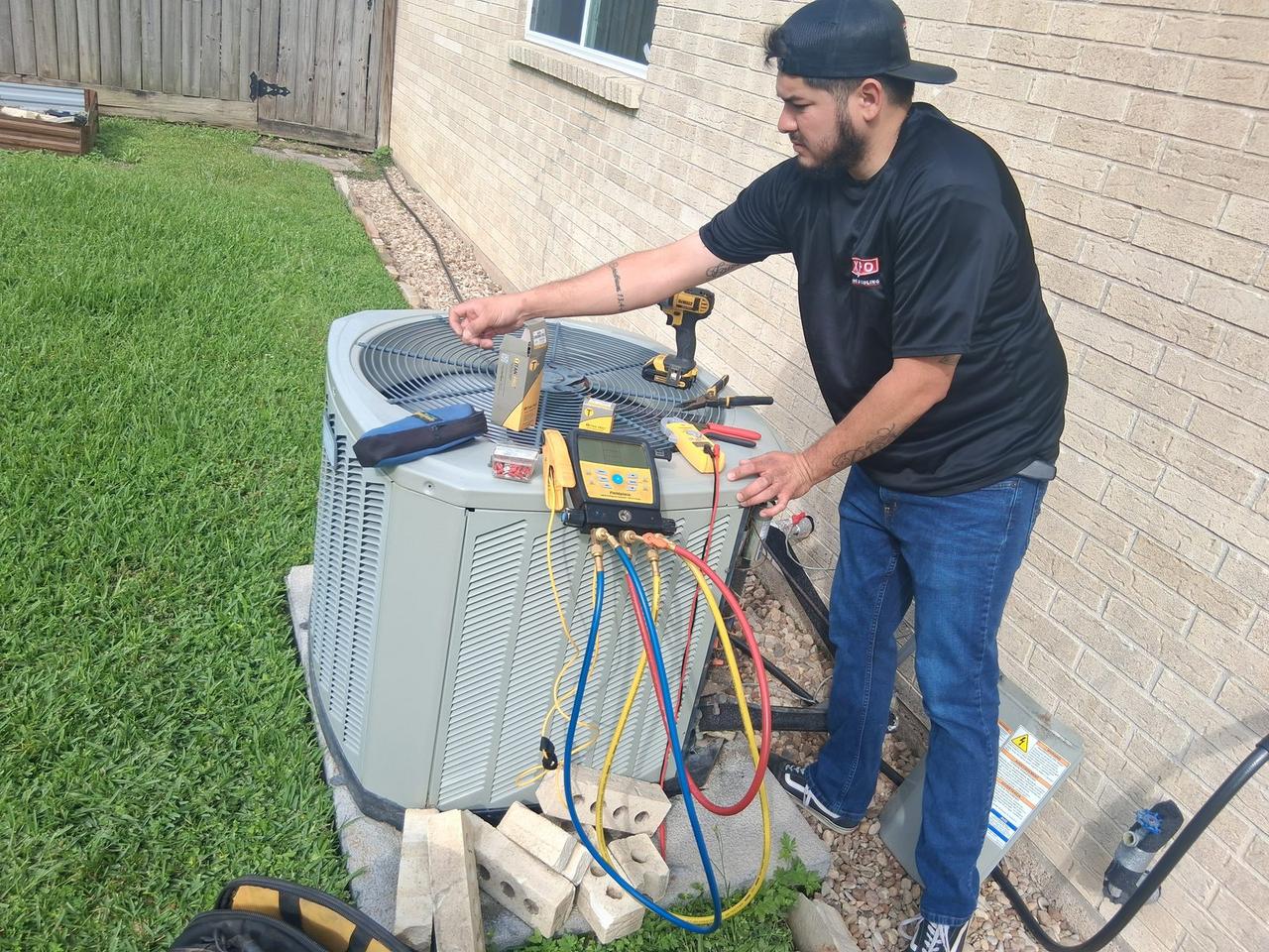 AC Repair Expo technician testing a run capacitor with Fieldpiece gauges on a Carrier condenser in Spring TX