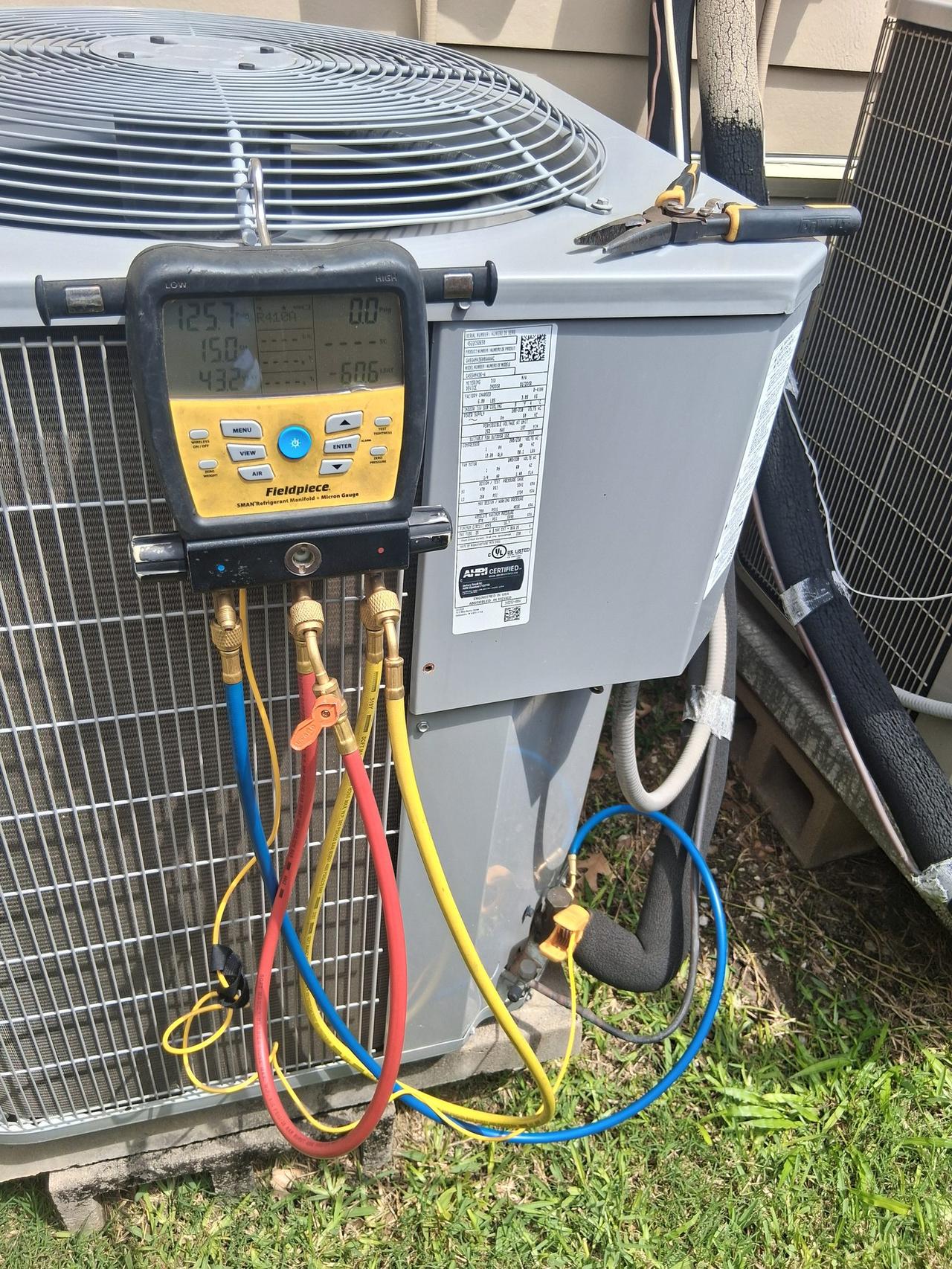 AC Repair Expo diagnosing an outdoor condenser unit with Fieldpiece gauges and R-454B refrigerant in Spring TX