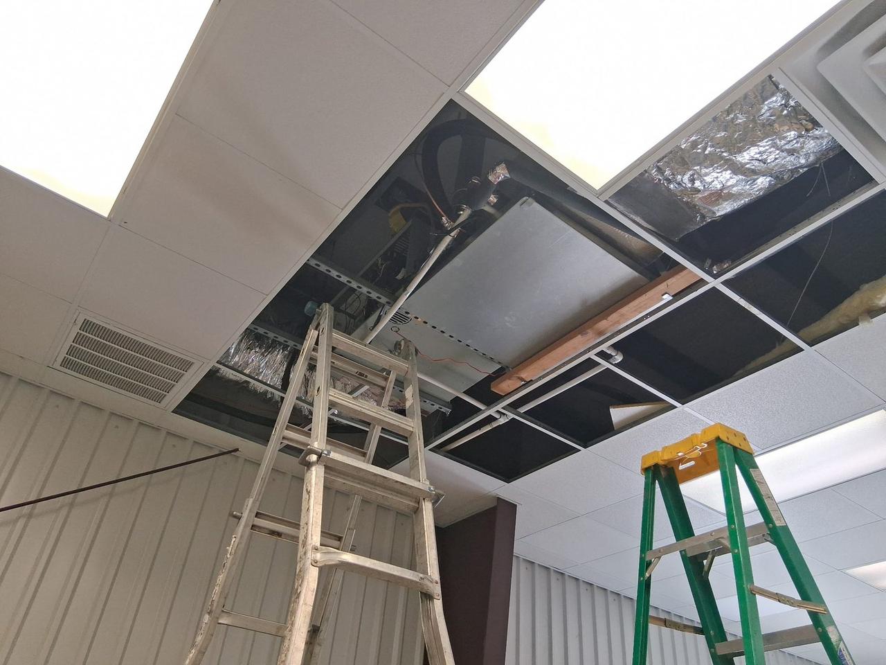AC Repair Expo servicing commercial HVAC ductwork above the ceiling at a Spring TX business