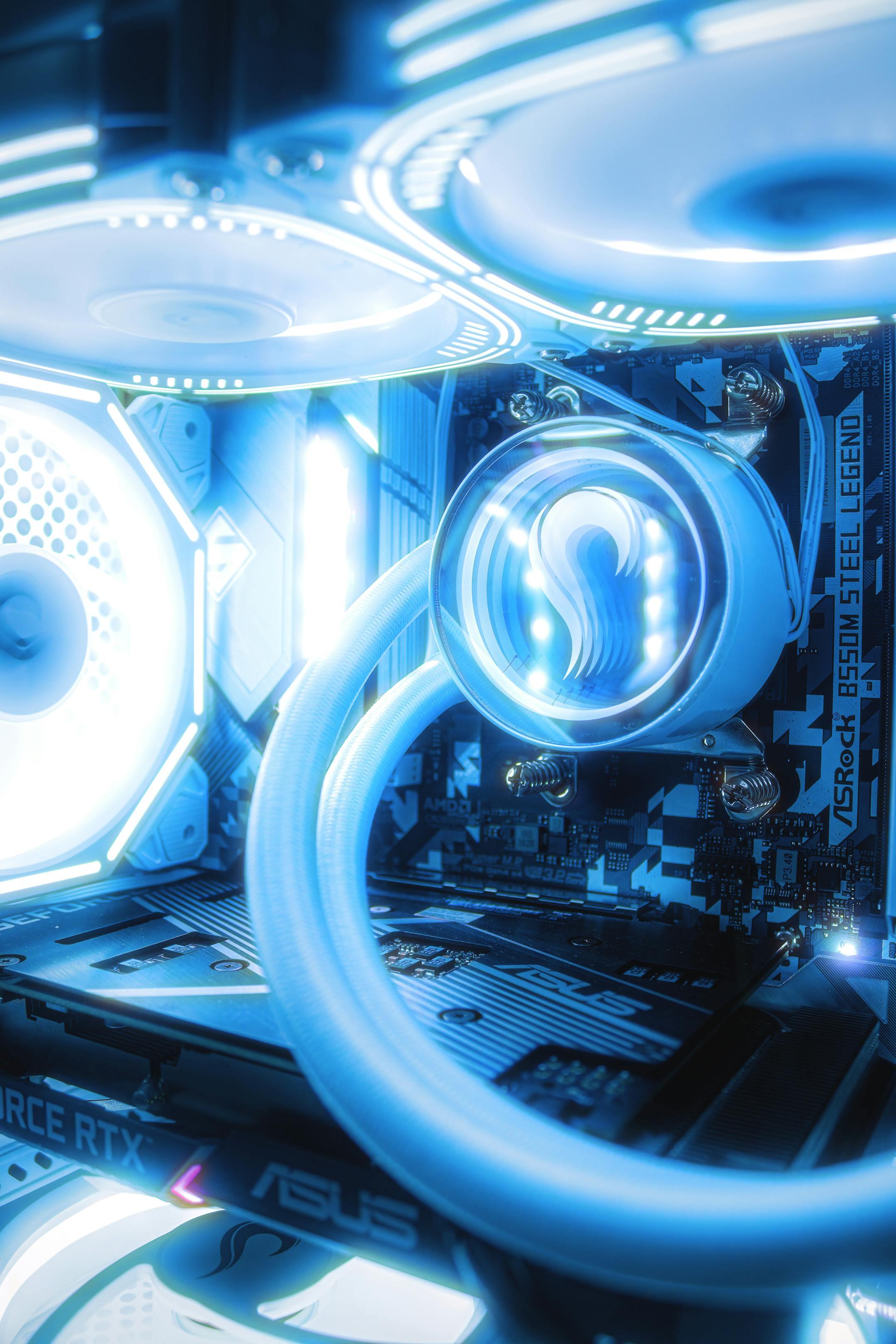 Close-up of a gaming PC with illuminated RGB lights and advanced cooling system.