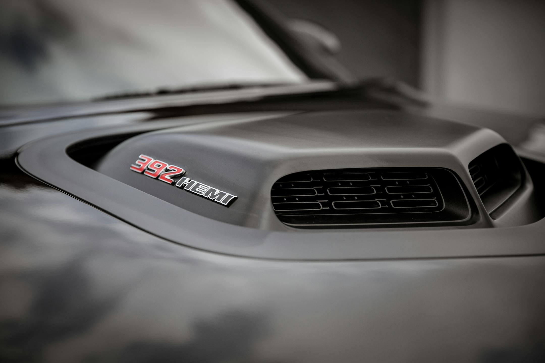 Detailed view of a car hood featuring a 392 HEMI badge and air intake.