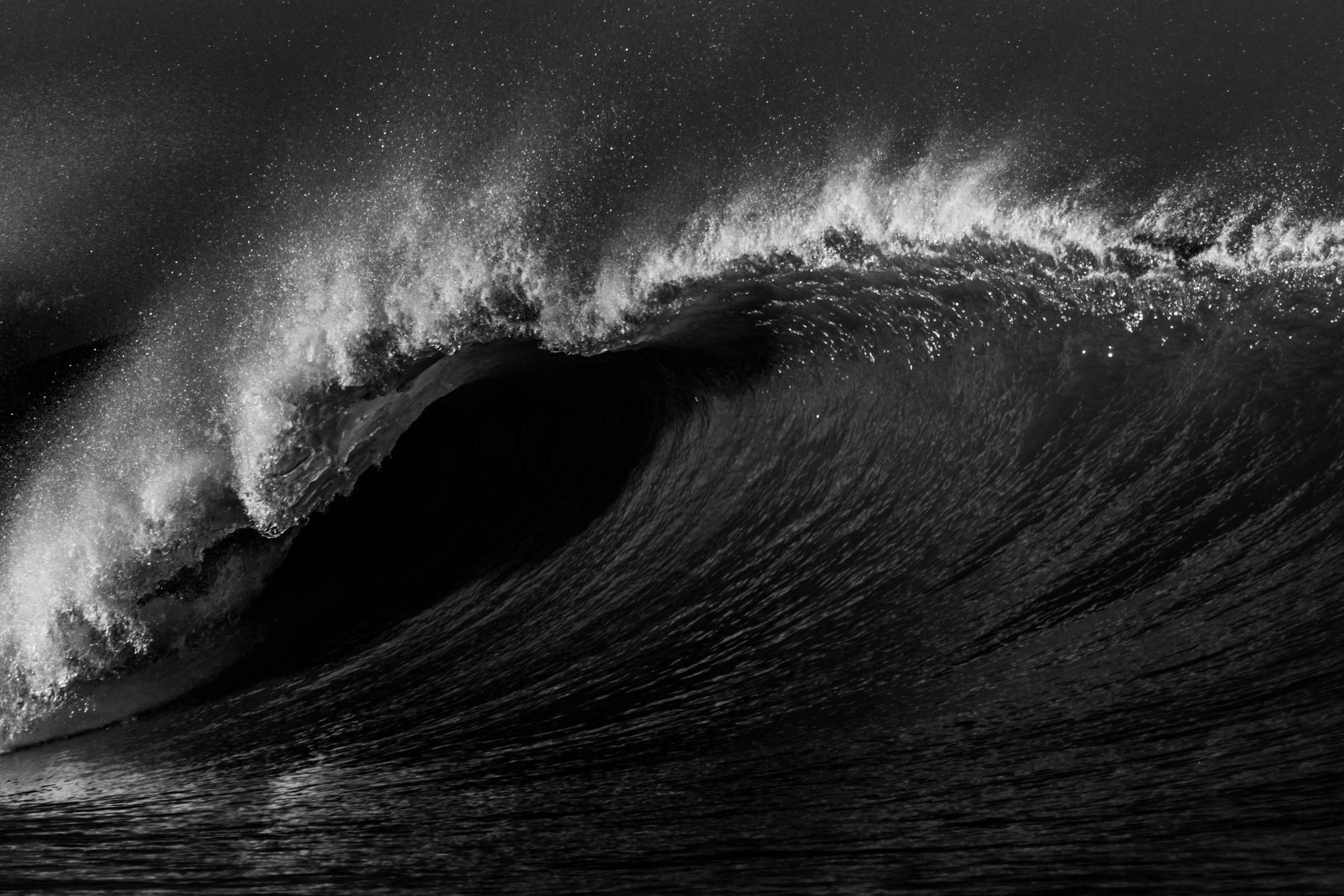 A powerful ocean wave captured in stunning black and white contrast.
