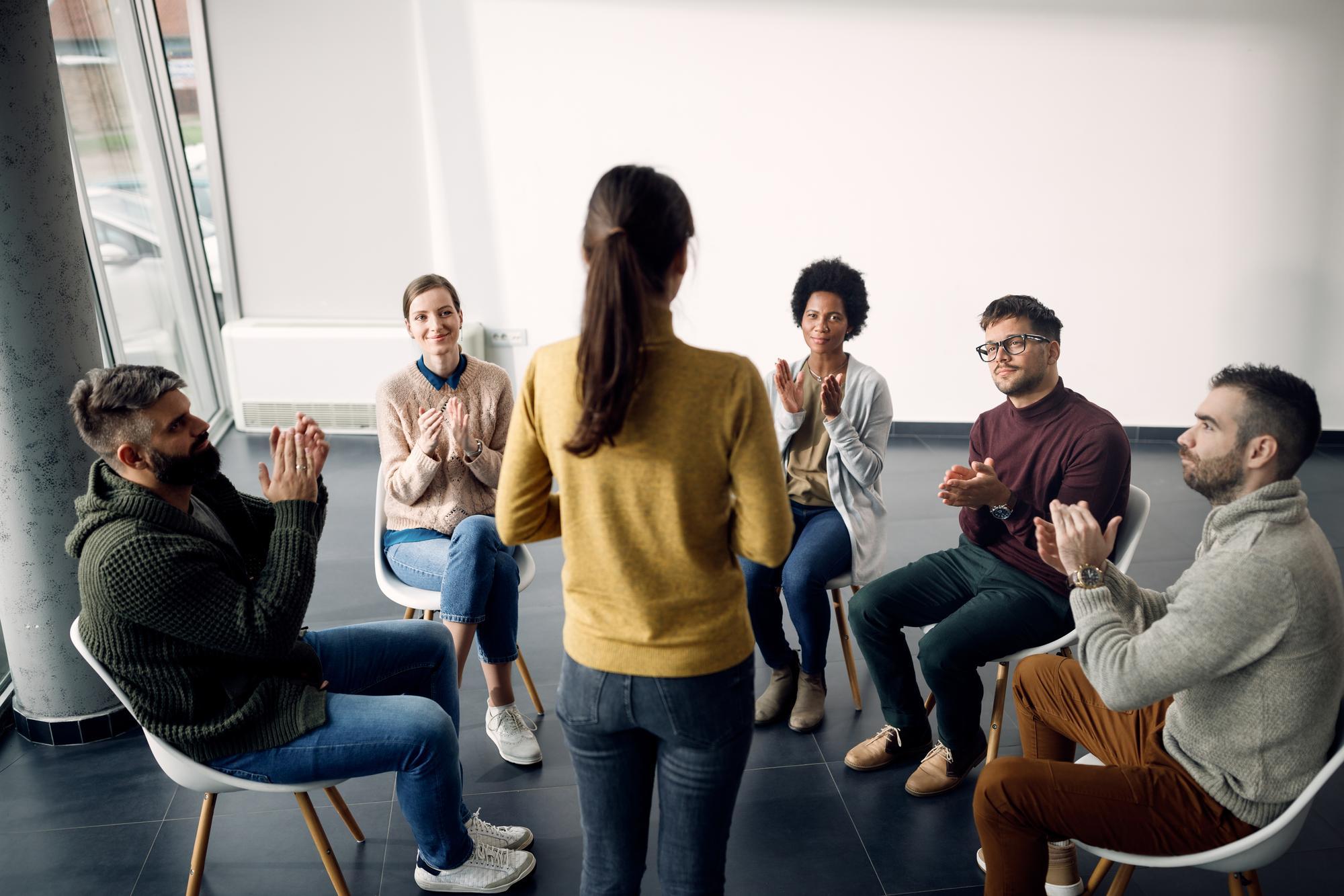 group-therapy-attenders-applauding-one-participant-during-meeting.jpg