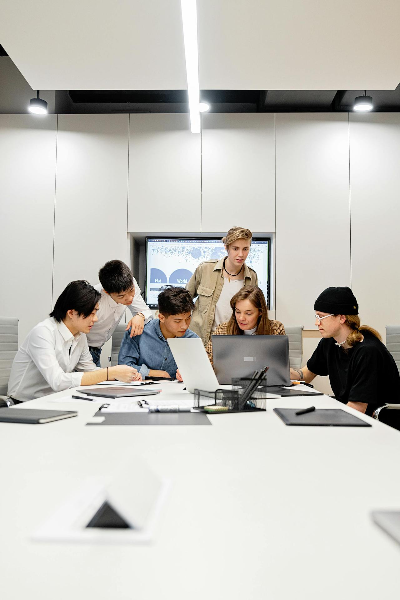 A group of professionals engaged in a conference room meeting, fostering teamwork and collaboration.