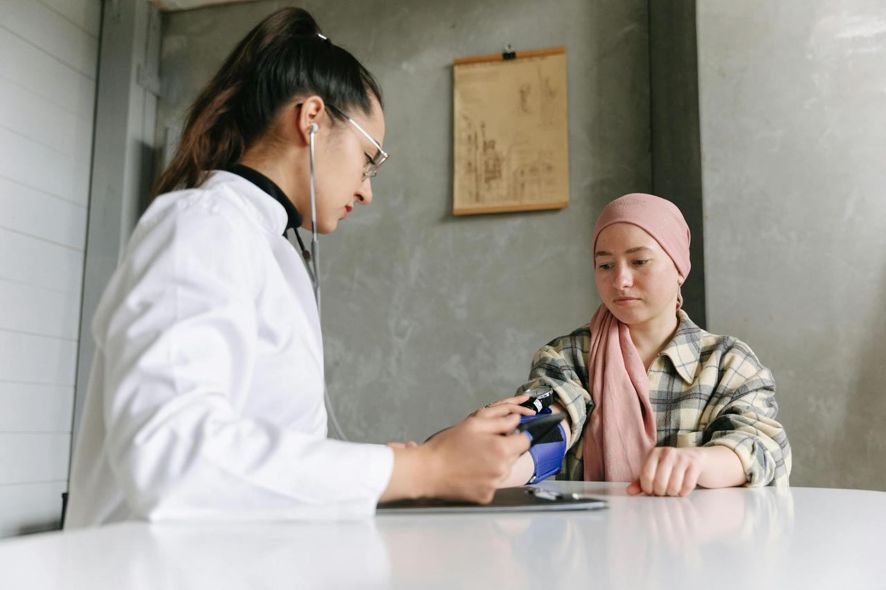 A medical professional checks a patient's blood pressure, depicting a caring healthcare environment.