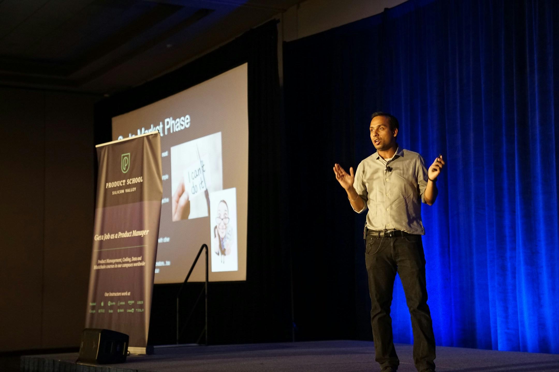 man speaking on stage
