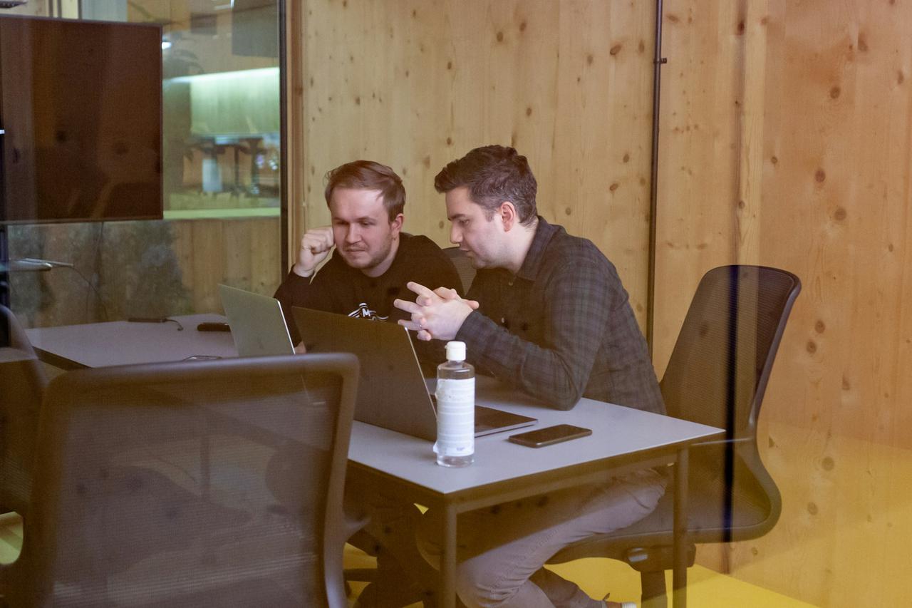 Two colleagues having a meeting in a small conference room
