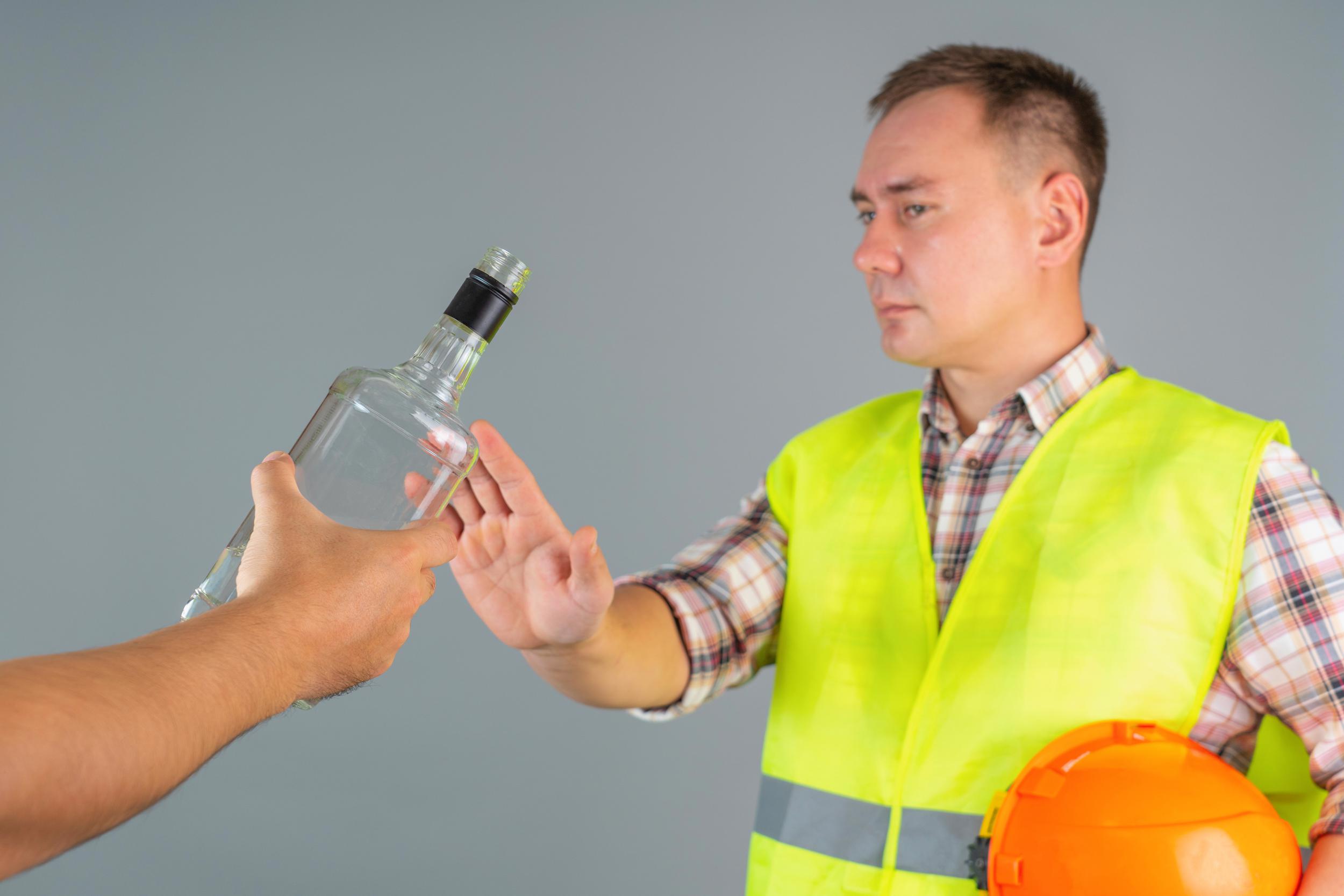 male-construction-worker-work-clothes-refuses-proffered-bottle-strong-alcohol-refusal-drink-work.jpeg