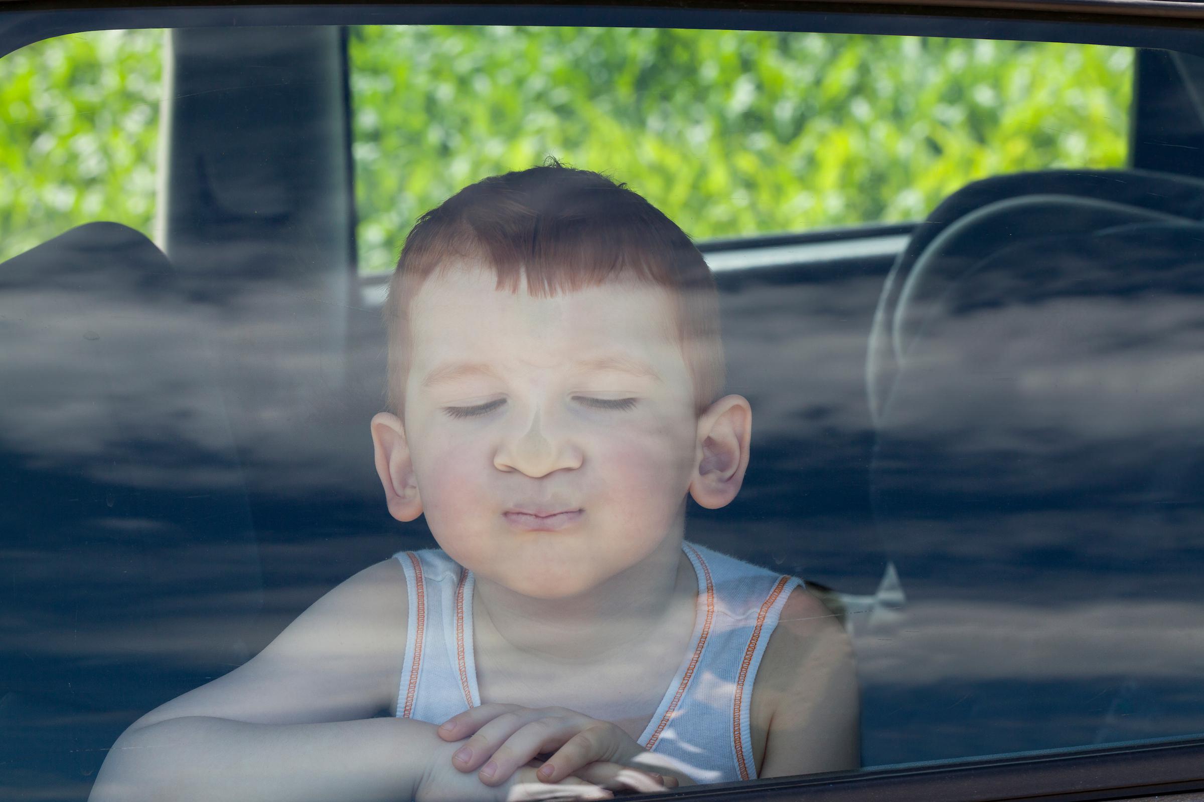 A child pressing their face against a window.