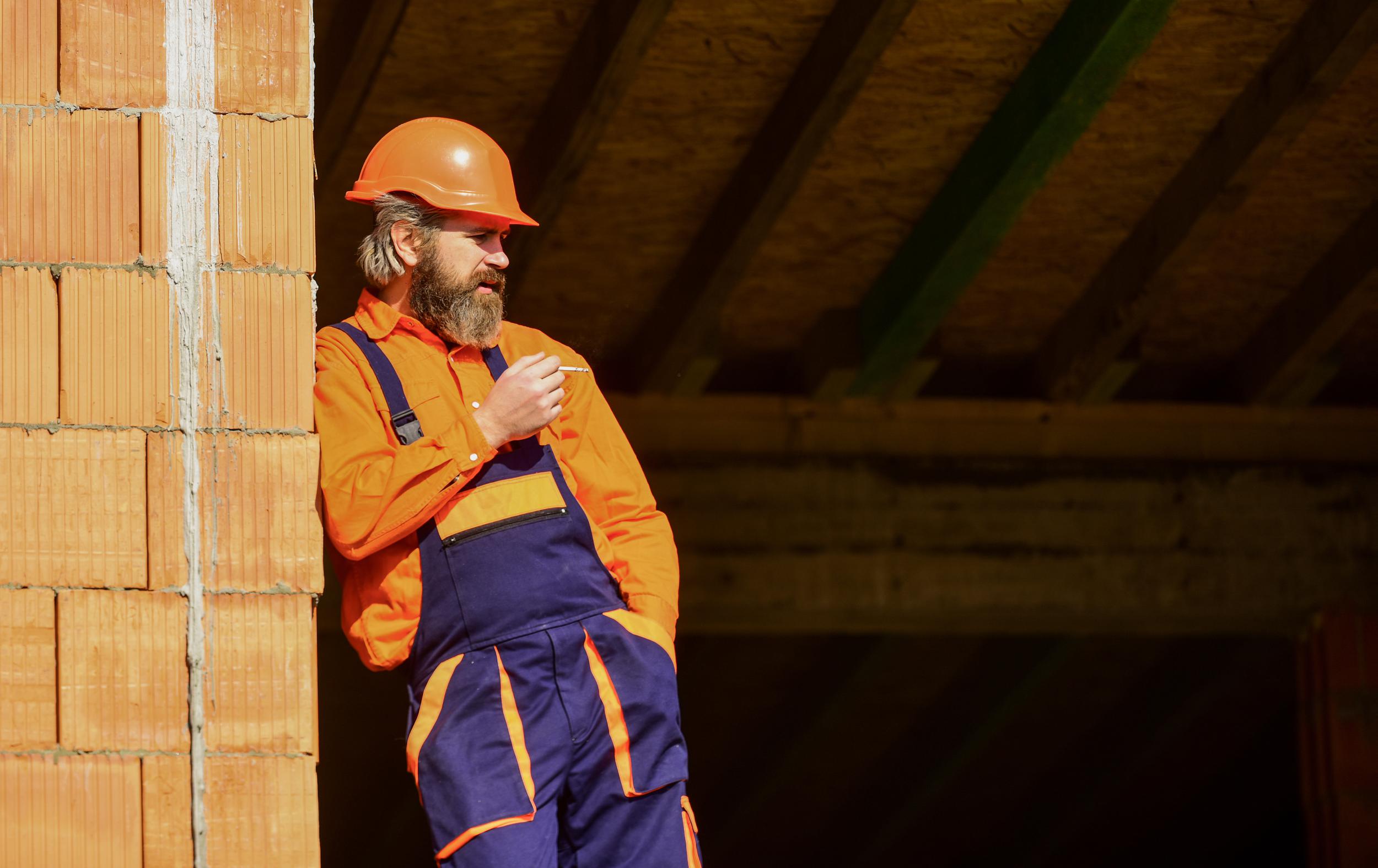 tired-builder-relax-construction-worker-smoking-cigarette-building-is-construction-bearded-man-uniform-hard-hat-repairman-engineer-wear-helmet-site-copy-space.jpeg